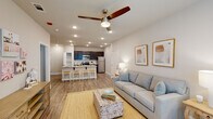 This thoughtfully designed 1-bedroom, 1-bathroom unit in Hammond, Louisiana delivers a comfortable and functional living experience across a single floor. The open-concept layout connects the living area to the kitchen seamlessly, creating a bright and inviting atmosphere enhanced by recessed lighting and ceiling fans throughout.

The living room features warm wood-look flooring, large windows dressed with sheer curtains and blinds that allow natural light to fill the space, and ample room for relaxed seating. The kitchen is a standout feature, showcasing rich dark cabinetry, granite countertops, a white subway tile backsplash, and a full suite of stainless steel appliances including a refrigerator, electric range, and microwave. A spacious island with a built-in sink and bar seating provides additional prep space and casual dining.

The bedroom is generously proportioned with wood-look flooring, a ceiling fan, natural light from a window, and convenient access to a walk-in closet. The bathroom offers dark cabinetry paired with granite countertops and a single vanity, while in-unit washer and dryer hookups are conveniently located nearby. Neutral tones and clean finishes throughout give the space a modern, cohesive aesthetic.