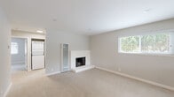 Located in Sunnyvale, CA, this single-story 2-bedroom, 1-bathroom home offers a well-designed layout with a clean, neutral aesthetic throughout. The living room serves as the heart of the home, anchored by a classic white brick fireplace and plush carpeting underfoot. Large windows fitted with white blinds invite generous natural light and offer views of surrounding greenery, creating a bright and welcoming atmosphere. A stacked washer and dryer unit is conveniently accessible from the living area. The entry foyer features warm wood-look flooring and a large window that further enhances the sense of openness upon arrival. The kitchen has been thoughtfully updated with crisp white shaker cabinetry, white quartz countertops, and stainless steel appliances including a range, microwave, and dishwasher, all set over durable wood-look flooring. The bathroom features an elegant marble-look surround tub-shower combo with brushed nickel fixtures and wood-look flooring. The primary bedroom offers carpeted comfort, a mirrored sliding closet, and a window with outdoor views. The second bedroom also features wood-look flooring and a window with natural light. Neutral wall tones and clean finishes give the home a move-in ready feel throughout.