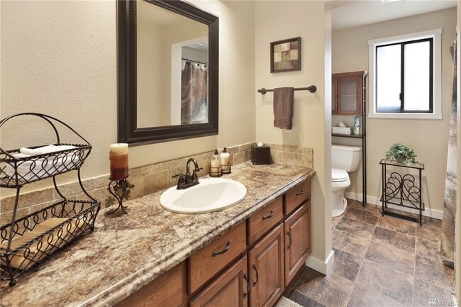 Downstairs remodeled bathroom has full bathtub (not pictured) - 6924 Petticote Ln