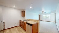 This well-designed 2-bedroom, 1-bathroom residence in Northfield, MN offers a comfortable and functional layout across a single floor. The open-concept kitchen and dining area features warm wood cabinetry, a stainless steel dishwasher, a double-basin sink, and a peninsula that flows seamlessly into the carpeted living room — complete with a ceiling fan and natural light streaming through a large window. The kitchen is also equipped with stainless steel appliances, including a refrigerator and microwave.

Both bedrooms are generously proportioned with plush carpeting, warm wood-trimmed doors, and windows that bring in outdoor views of the surrounding greenery. The primary bedroom includes a ceiling fan and direct closet access, while each bedroom benefits from dedicated closet space — with three closets distributed throughout the unit for ample storage.

The bathroom features a clean, full-sized tub and shower combo with light wood-style flooring. Additional practical spaces include a utility room and a private balcony, ideal for enjoying the outdoors. Consistent warm wood door trim and red-toned baseboards throughout lend a cohesive, inviting character to the entire residence.