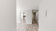 Located at 303 Notch Hill Rd in North Branford, Connecticut, this well-appointed one-bedroom, one-bathroom residence occupies a single floor with a thoughtfully designed layout. Wood-look plank flooring in a light, weathered finish runs consistently throughout every room, lending a cohesive and contemporary aesthetic to the entire space.

The open living area flows naturally toward the kitchen, which serves as a standout feature of the home. It is equipped with crisp white shaker-style cabinetry, dark granite countertops, a full suite of stainless steel appliances—including a dishwasher, range, microwave, and refrigerator—and a stainless sink, all illuminated by flush-mount ceiling lighting. An adjacent dining or flex area benefits from a bright window with blinds, adding natural light to the space.

The bedroom is generously proportioned, featuring a large window that brings in natural light and offers views of the surrounding area. Notably, it includes two full closets, providing ample storage. Additional closet space is found elsewhere in the unit, complemented by a dedicated utility room.

The bathroom is cleanly finished with a tub-shower combination, white cabinetry with dark countertops matching the kitchen, and the same wood-look flooring carried throughout. The neutral gray-toned walls across all rooms create a calm, modern ambiance that is both inviting and versatile.