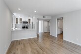Located at 1840 N Kenmore Ave in the desirable Los Feliz neighborhood of Los Angeles, this single-floor unit offers a bright, modern living environment defined by clean lines and thoughtful design throughout. Light-toned hardwood flooring runs seamlessly across the entire space, creating a warm and cohesive aesthetic in every room.

The open living area is generously proportioned, featuring recessed lighting, a sliding glass door with vertical blinds providing access to an outdoor area, and a distinctive bay window that floods the space with natural light and adds architectural character. Adjacent rooms continue the airy feel, each benefiting from large windows dressed with vertical blinds that offer both privacy and sun control.

The primary bedroom is well-appointed with a mirrored sliding-door closet and access to a dedicated walk-in closet outfitted with built-in shelving and hanging rods, offering exceptional storage capacity. A second bedroom provides a comfortable, light-filled retreat with its own large window.

Both bathrooms are finished in a clean, contemporary style, each featuring a white vanity with marble-look countertops, a tub-shower combination with chrome fixtures, and recessed overhead lighting. The consistent use of light tones and quality finishes throughout the unit creates a cohesive, move-in-ready environment in one of LA's most vibrant neighborhoods.