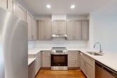 This 620 square foot apartment in Fairfax, VA offers a thoughtful blend of comfort and functionality. The single-floor layout maximizes space utilization, featuring one bedroom, one bathroom, and an open-concept kitchen and living area. The modern kitchen is a highlight, boasting light-colored cabinetry, stainless steel appliances, and a sleek quartz countertop with a convenient breakfast bar. The living space flows seamlessly from the kitchen, creating an inviting area for relaxation and entertainment.

The bedroom, measuring 170 square feet, provides ample space and is equipped with a large closet for storage. It features warm wood flooring and large windows that allow natural light to flood the room. The bathroom is well-appointed with a full-sized tub, built-in shelving, and clean, modern finishes.

Throughout the apartment, recessed lighting and ceiling fans enhance the ambiance and comfort. The use of neutral colors and contemporary design elements creates a fresh, inviting atmosphere. Large windows in the living area and bedroom offer views of the surrounding greenery, connecting the interior space with the outdoor environment. This apartment combines efficiency with style, making it an ideal living space for those seeking a modern, low-maintenance home in a convenient Fairfax location.