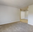 This 720 square foot apartment offers a thoughtful layout with 3 bedrooms and 2 bathrooms on a single floor. The modern kitchen is a highlight, featuring sleek gray cabinetry, stainless steel appliances, and a subway tile backsplash. Light wood-look flooring in the kitchen and living areas creates a bright, open feel. Bedrooms are carpeted for comfort and include ample closet space, with one bedroom showcasing a walk-in closet with built-in shelving. Bathrooms are updated with contemporary fixtures, including a tiled shower/tub combination and a vanity with a marble-look countertop. Large windows in the bedrooms and a sliding glass door in one room provide natural light and potential outdoor access. The neutral color palette throughout allows for personalization. Despite its compact size, this apartment efficiently utilizes space to offer comfortable living in a modern setting.