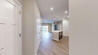 Located at 1 Mossy Grove Lane in Delaware, Ohio, this single-floor, one-bedroom, one-bathroom residence offers a thoughtfully designed layout with modern finishes throughout. The open-concept kitchen and living area serves as the heart of the home, featuring warm wood-look luxury vinyl plank flooring, recessed lighting, and a seamless flow between spaces. The kitchen is well-appointed with rich dark-toned cabinetry, stainless steel appliances including a refrigerator with ice maker, range, and microwave, as well as a central island with a white countertop and pendant lighting overhead — providing both prep space and a casual gathering spot. The living area opens directly to a private balcony through a sliding glass door with vertical blinds, offering an inviting connection to the outdoors. The bedroom is generously proportioned with plush carpeting, a ceiling fan with light fixture, and a large window that brings in natural light. A dedicated closet provides practical storage. The bathroom is finished with wood-look flooring, dark cabinetry with a wide white-top vanity, a large mirror, and a tub-shower combination. Neutral wall tones and clean white trim throughout create a bright, cohesive ambiance across the entire residence.