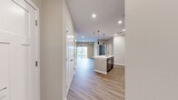 Located at 1 Mossy Grove Lane in Delaware, Ohio, this single-floor, one-bedroom, one-bathroom residence offers a thoughtfully designed layout with modern finishes throughout. The open-concept kitchen and living area serves as the heart of the home, featuring warm wood-look luxury vinyl plank flooring, recessed lighting, and a seamless flow between spaces. The kitchen is well-appointed with rich dark-toned cabinetry, stainless steel appliances including a refrigerator with ice maker, range, and microwave, as well as a central island with a white countertop and pendant lighting overhead — providing both prep space and a casual gathering spot. The living area opens directly to a private balcony through a sliding glass door with vertical blinds, offering an inviting connection to the outdoors. The bedroom is generously proportioned with plush carpeting, a ceiling fan with light fixture, and a large window that brings in natural light. A dedicated closet provides practical storage. The bathroom is finished with wood-look flooring, dark cabinetry with a wide white-top vanity, a large mirror, and a tub-shower combination. Neutral wall tones and clean white trim throughout create a bright, cohesive ambiance across the entire residence.