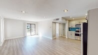Located at 1410 E Butler Pike in Ambler, PA, this thoughtfully renovated single-floor unit offers a clean, modern aesthetic throughout. The open-concept living and dining area is bathed in natural light, with light-toned luxury vinyl plank flooring flowing seamlessly across the space. A sliding glass door provides direct access to a private outdoor area, enhancing the sense of openness.

The kitchen is a standout feature, showcasing crisp grey shaker-style cabinetry with matte black hardware, bright white countertops, and a vivid teal subway tile backsplash that adds a bold design accent. A full suite of stainless steel appliances — including a refrigerator, electric range, built-in microwave, and dishwasher — completes this functional and stylish cooking space.

The bedrooms are spacious and serene, finished with the same light hardwood-style flooring and neutral wall tones. Large windows with white shutters invite ample natural light while maintaining privacy. Recessed lighting throughout ensures consistent illumination in every room.

The bathroom is appointed with large-format neutral tile, a sliding glass-enclosed walk-in shower with matte black fixtures, and clean, minimalist finishes. Every detail of this unit reflects a commitment to contemporary design and quality craftsmanship.