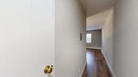 Located at 1560 N Prospect Ave in Milwaukee's vibrant East Side neighborhood, this one-bedroom, one-bathroom unit offers a well-organized and efficiently designed single-floor layout. The kitchen is a standout feature, showcasing white shaker-style cabinetry, granite countertops, a classic white subway tile backsplash, and a full suite of stainless steel appliances including a range, microwave, and dishwasher — all set above warm hardwood-style flooring. The bedroom is a comfortable, carpeted retreat featuring a ceiling fan, a window that invites natural light, and two closet doors providing ample storage. Neutral, warm-toned walls throughout create a calm and cohesive aesthetic. The bathroom offers a full tub and shower combination accented by classic teal square tilework and a window above the tub for added ventilation and light. A connecting hallway ties the rooms together seamlessly. Baseboard heating is present in both the bedroom and kitchen areas, ensuring year-round comfort. The unit's thoughtful layout and updated finishes make it a practical and inviting living space in one of Milwaukee's most walkable and desirable neighborhoods.