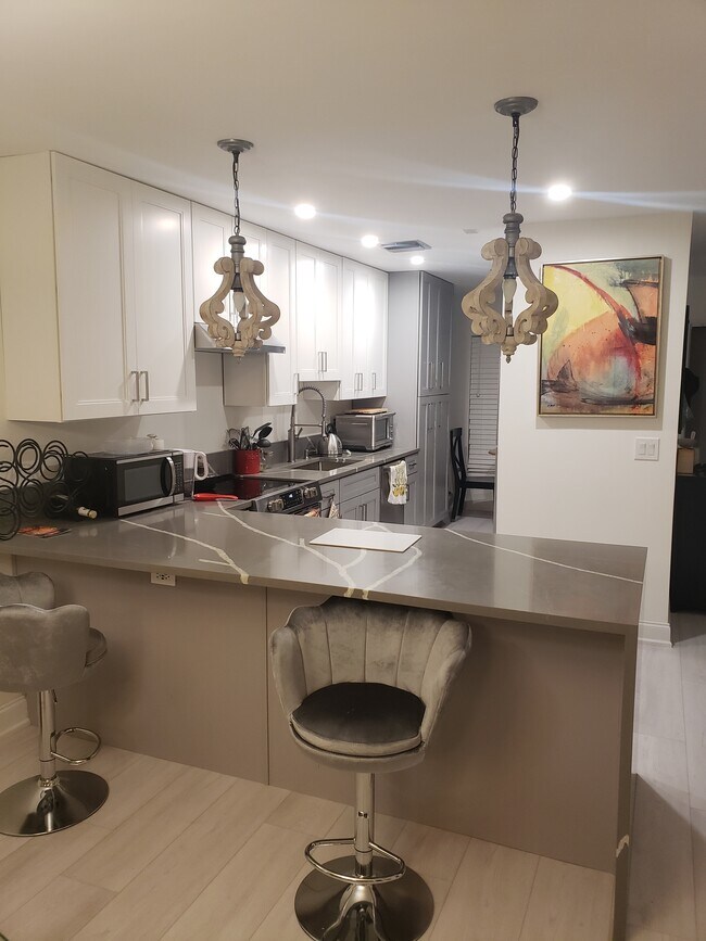 Updated kitchen with bar stools - 1041 Orange Ter