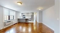 Located at 3 Davenport Avenue in New Rochelle, NY, this well-appointed three-bedroom, two-bathroom residence offers a thoughtfully designed single-level layout. Rich parquet hardwood flooring flows throughout the living areas and bedrooms, adding warmth and classic character to the space.

The open-concept living and dining area is generously proportioned, bathed in natural light from large windows with views of the surrounding neighborhood. The modern kitchen features sleek gray cabinetry, a peninsula with a white countertop, and a full suite of stainless steel appliances including a gas range, over-the-range microwave, and a full-size refrigerator. Light tile flooring and a window over the sink add brightness and functionality.

The primary bedroom is spacious and well-lit, with a large window and the same warm parquet flooring. The two additional bedrooms are comfortable and bright, each with natural light and easy access to the hallway.

Both bathrooms have been tastefully updated with marble-style wall and floor tiling. The full bath includes a glass-enclosed shower, floating vanity, and a mirrored medicine cabinet, while the second bath offers a clean, minimalist design with matching finishes throughout. The overall ambiance is clean, modern, and move-in ready.