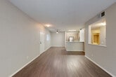 Located at 4656 Quigg Dr in Santa Rosa, CA, this single-story, one-bedroom, one-bathroom residence offers a well-designed layout that maximizes functionality and comfort. The open-concept living, dining, and kitchen area forms the heart of the home, featuring durable wood-style flooring and a ceiling fan that enhances airflow throughout the space. A front entry door with a sidelight brings in natural light, creating a bright and welcoming atmosphere.

The kitchen is equipped with stainless steel appliances, including a gas range, microwave, and refrigerator, complemented by light wood cabinetry and a clean white countertop peninsula that doubles as a breakfast bar. A built-in pass-through window connects the kitchen area to an adjacent nook, adding architectural interest and visual depth.

The bedroom is carpeted for comfort and features a ceiling fan, a large window overlooking greenery, and a dedicated closet with built-in shelving, offering ample storage. An additional closet provides further organizational space. The bathroom includes a full tub-shower combination with chrome fixtures and a wood-toned wall cabinet for storage. A hallway connects the rooms cohesively, completing this efficiently designed single-floor residence.