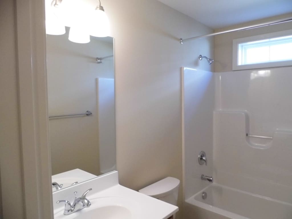 The full bath offers a counter height vanity, large mirror - 2312-A Belle Ave NE
