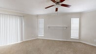 Located at 1100 Langwick Dr in Houston, TX, this single-floor 2-bedroom, 1-bathroom home offers a practical and comfortable layout designed for everyday living. The galley-style kitchen is a standout feature, boasting white cabinetry, granite-look countertops, light tile flooring, and a full suite of stainless steel appliances including a range, microwave, refrigerator, and dishwasher. The layout flows efficiently through a connecting hallway that links the main living areas to the bedrooms and bathroom. The primary bedroom is a generous, well-lit space featuring soft carpeting, crown molding, a ceiling fan with light fixture, a decorative wall-mounted shelf, and multiple windows with blinds that allow natural light to fill the room. A sliding vertical blind panel provides access to an additional area. The second bedroom is cozy and carpeted, with a ceiling fan and a window overlooking the exterior. Both bedrooms are served by two dedicated closets. The bathroom is clean and functional, equipped with a full soaking tub and shower combination with built-in wall niches. Throughout the home, neutral tones and clean white trim create a bright, cohesive ambiance.