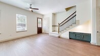 Located at 3812 Viridian Park Ln in Arlington, TX, this two-story home offers four bedrooms and three bathrooms across two well-proportioned floors. The main level features a bright, open living area with light hardwood flooring, neutral walls, and natural light flowing in through windows flanking a handsome wood-framed front door. The kitchen is thoughtfully designed with sage-toned shaker cabinetry extending to the ceiling, stainless steel appliances including a gas range and French door refrigerator, a white quartz countertop island, and warm wood-look flooring. A clean, pedestal-sink powder bath with marble-style tile flooring rounds out the main level. Upstairs, the generously sized primary bedroom offers plush carpeting and ample room, complemented by a walk-in closet with built-in shelving and dual hanging rods. The primary bathroom stands out with striking teal cabinetry, marble-look tile flooring and walls, a frameless glass walk-in shower, and a wide vanity with undermount sink. Three additional carpeted bedrooms provide flexible space for family or guests. The dedicated laundry room houses a full-size front-load washer and dryer with overhead shelving. The home's consistent neutral palette and modern finishes create a clean, cohesive ambiance throughout.