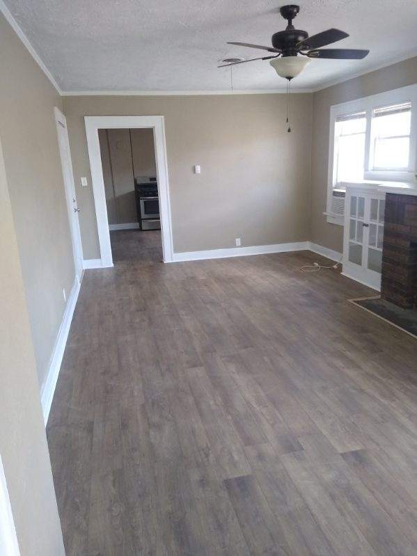 Large Living room with new flooring and built-in cabinets - 118 S B St