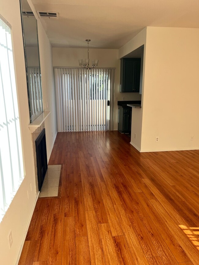 Large living room with a fireplace and private balcony - 7039 Kittyhawk Ave
