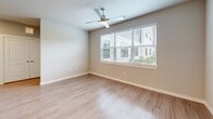 Located at 10191 Main St in Houston, TX, this well-appointed two-bedroom, two-bathroom residence offers a thoughtfully designed single-floor layout with a clean, modern aesthetic. Wood-style plank flooring runs throughout, complemented by neutral warm-gray walls and crisp white trim that create a bright, cohesive atmosphere.

The open-concept kitchen is a standout feature, showcasing white shaker-style cabinetry extending to the ceiling, granite countertops, a tiled backsplash, and a full suite of stainless steel appliances including a refrigerator, range, and over-the-range microwave. A large island with a built-in sink provides additional workspace and connects seamlessly to the combined dining and living area, which is filled with natural light from generously sized windows.

Both bedrooms are comfortably sized, each featuring windows with outdoor views, ceiling fans, and easy access to closet storage — six closets are distributed throughout the unit, offering excellent organization options. The primary bedroom includes its own private bathroom. Both bathrooms are finished consistently with granite vanity tops, white cabinetry, subway-tiled tub-shower combinations, and wood-style flooring. Additional conveniences include a dedicated laundry room, entrance foyer, and multiple hallways ensuring a smooth flow between spaces.
