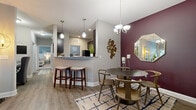 Located in Charlotte, NC, this thoughtfully designed 2-bedroom, 2-bathroom residence offers a comfortable and stylish living experience across a single floor. The open-concept layout connects the living, dining, and kitchen areas seamlessly, creating a welcoming flow throughout the home. The living room features a bold navy accent wall, wood-look flooring, a ceiling fan, and a glass door that invites abundant natural light. Adjacent to the living area, the dining space is highlighted by a rich burgundy accent wall, pendant chandelier, and direct access to the kitchen via a breakfast bar with counter seating. The kitchen is equipped with dark espresso cabinetry, granite-style countertops, black appliances, and wood-look flooring, providing both style and functionality. The spacious primary bedroom features soft carpet, a teal accent wall, a ceiling fan, and large windows with outdoor views. Its en-suite bathroom includes a dark vanity, tile flooring, and a glass-enclosed shower. The second bedroom mirrors the primary's comfort with similar finishes and natural light. The second bathroom offers a tub-shower combo and a dark vanity with tile flooring. A dedicated in-unit laundry room with a full-size washer and dryer adds everyday convenience. Two closets provide ample storage throughout the home.