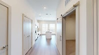Located at 1602 Belt Line Rd in Garland, TX, this single-story, one-bedroom, one-bathroom unit offers a thoughtfully designed layout with modern finishes throughout. The open-concept living and kitchen area is anchored by a central island topped with granite countertops and an undermount sink, providing both functionality and visual appeal. The kitchen is equipped with stainless steel appliances, including a side-by-side refrigerator with ice maker, an electric range, and a built-in microwave, all complemented by crisp white cabinetry that extends to the ceiling for ample storage. A large window allows natural light to pour in, brightening the space. Warm wood-look plank flooring runs throughout the main living areas, adding a cohesive and contemporary feel. The living area features a ceiling fan with a brushed gold finish and a stylish barn door that adds a modern accent. The bedroom is carpeted for comfort, fitted with its own ceiling fan, and connects to a closet area. The bathroom is clean and well-appointed, featuring a soaking tub with a tiled surround in a neutral marble-like pattern and brushed nickel fixtures, creating a calm and polished retreat.
