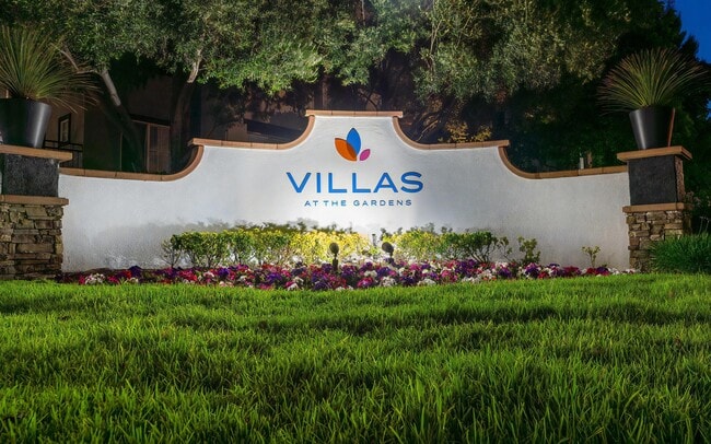 Lit planting at the entry makes the community easy to find after dark. - Villas at the Gardens