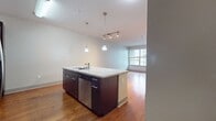 This contemporary 1-bedroom, 1-bathroom apartment in San Diego offers 710 square feet of thoughtfully designed living space. The heart of the home is a sleek, open-concept kitchen and living area, showcasing dark wood cabinetry, stainless steel appliances, and a spacious granite-topped island. Pendant lighting adds a touch of sophistication to the space.

The living area features rich hardwood flooring and large windows that flood the space with natural light. The bedroom, measuring 140 square feet, is carpeted for comfort and includes a ceiling fan. A generous closet provides ample storage space.

The bathroom boasts a modern vanity with a expansive countertop and undermount sink. Tile flooring and a glass-enclosed shower complete the space. Throughout the apartment, neutral wall colors create a blank canvas for personal style.

This unit, located at 1330 Market #505 in San Diego, CA 92101, exemplifies urban living with its efficient use of space and high-end finishes. The single-floor layout ensures easy accessibility and maintains a cohesive design throughout.