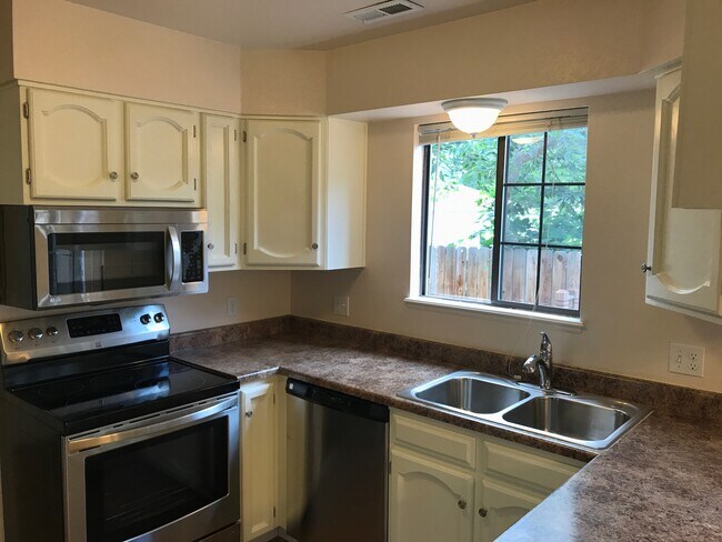 Newly renovated kitchen looks into large fenced backyard - 5205 Cody St