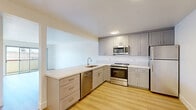 Located at 544 Central Ave in Alameda, CA, this single-floor, three-bedroom, one-bathroom home offers a clean and functional layout with modern updates throughout. The open living area features light wood-tone flooring and crisp white walls, creating a bright and welcoming atmosphere that flows seamlessly into the kitchen. The kitchen is well-appointed with gray shaker-style cabinetry, light quartz countertops, and a full suite of stainless steel appliances including a refrigerator, electric range, over-the-range microwave, and dishwasher — all set against a classic white tile backsplash. A pass-through counter connects the kitchen to the living area, enhancing the sense of openness. The three bedrooms feature neutral carpet flooring and clean white walls, with the primary bedroom offering a comfortable and private retreat. At least one bedroom benefits from a window with natural light and outdoor views. The bathroom is finished with a white vanity topped with a stone-look countertop, wood-tone flooring, and a tub-shower combination with sliding glass doors. Throughout the home, the design is clean and contemporary, emphasizing practicality and comfort in a well-organized single-level floor plan.