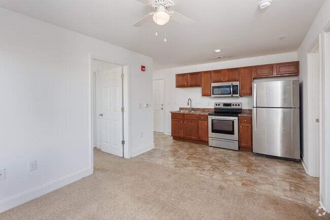 Carpeted living room towards kitchen. - 1200 Hemingway Chapel Rd