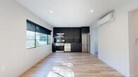 Located in the vibrant Silver Lake neighborhood of Los Angeles, this modern 2-bedroom, 1-bathroom home offers a thoughtfully designed single-floor layout with clean, contemporary finishes throughout. Light wood-style flooring flows seamlessly from room to room, complemented by crisp white walls and recessed lighting that keep the space feeling bright and open.

The kitchen is a standout feature, showcasing sleek matte dark cabinetry that extends to the ceiling for maximum storage, dark granite countertops with a matching backsplash, a black-accented faucet, and a full suite of stainless steel appliances including a gas range, microwave, dishwasher, and refrigerator. A large window fills the kitchen and living area with generous natural light.

Both bedrooms are well-proportioned and bright, each featuring black-framed windows with outdoor views, recessed lighting, and wall-mounted mini-split HVAC units for individualized climate control. The primary bedroom includes double closet doors, offering ample storage. A connecting hallway with clean white interior doors links the bedrooms to the main living areas.

The bathroom features a sleek tub-shower combination enclosed by black-framed sliding glass doors, matte black fixtures, and a window for natural ventilation. A stacked in-unit washer and dryer adds everyday convenience to this efficiently designed Los Angeles home.