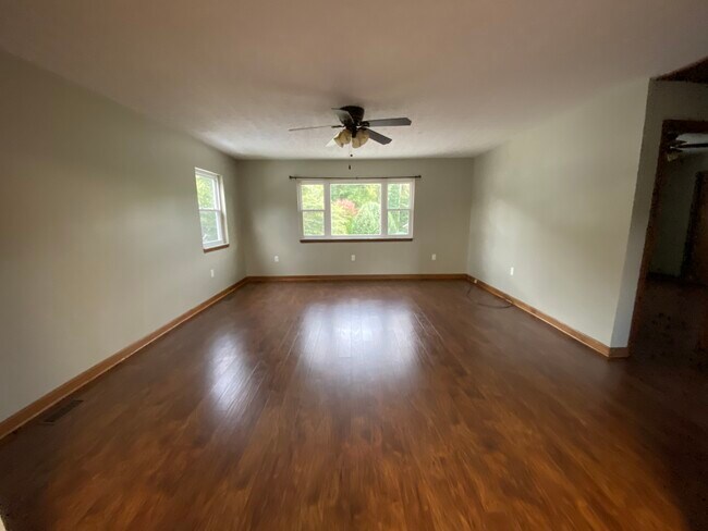 Large living room with updated flooring and lighting - 6057 Pineview Dr