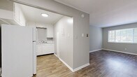 Located at 910 Brown Dr in Murfreesboro, TN, this single-story 2-bedroom, 1-bathroom home offers a practical and well-maintained layout. The interior features wood-look flooring throughout the main living areas, creating a clean and cohesive aesthetic. The living room is bright and open, with windows that allow natural light to fill the space. Adjacent to the living area, the compact kitchen is thoughtfully designed with white cabinetry, light countertops, a double sink, and white appliances including a refrigerator and electric range — all set atop matching wood-look flooring. A central hallway connects the main living spaces to the rest of the home. Both bedrooms are carpeted for comfort and equipped with ceiling fan light fixtures. The primary bedroom offers a generous footprint, while the second bedroom includes a window with natural light. The full bathroom features wood-look flooring, a tub-shower combination, and open shelving for added storage. Neutral gray tones throughout the walls, white trim, and consistent flooring choices give the home a cohesive, move-in ready appearance. The straightforward single-floor layout makes the space easy to navigate and functional for everyday living.