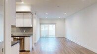 Located at 518 Gramercy in Los Angeles, CA, this modern 1-bedroom, 1-bathroom unit offers a thoughtfully designed single-story layout with clean architectural lines and a bright, contemporary aesthetic throughout. Light wood-tone flooring flows seamlessly across the open-concept living and dining area, which is bathed in natural light from sliding glass doors that lead directly to a private patio — ideal for indoor-outdoor living. Recessed lighting complements the crisp white walls and adds a polished ambiance to every room. The galley-style kitchen is well-appointed with stainless steel appliances, sleek white cabinetry, dark countertops, and a stylish herringbone tile backsplash, offering ample prep and storage space. The generously sized bedroom features its own sliding glass door to the patio, mirrored closet doors that amplify light and space, and convenient in-unit laundry access. The full bathroom is finished with large-format tile flooring, a floating white vanity with dark countertop, a frameless sliding glass tub-shower enclosure, and a broad wall mirror. Two closets provide excellent storage, and a hallway connects the spaces efficiently. This unit combines modern finishes with functional design in a prime Los Angeles location.