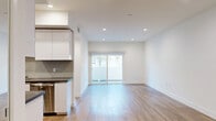 Located at 518 Gramercy in Los Angeles, CA, this modern 1-bedroom, 1-bathroom unit offers a thoughtfully designed single-story layout with clean architectural lines and a bright, contemporary aesthetic throughout. Light wood-tone flooring flows seamlessly across the open-concept living and dining area, which is bathed in natural light from sliding glass doors that lead directly to a private patio — ideal for indoor-outdoor living. Recessed lighting complements the crisp white walls and adds a polished ambiance to every room. The galley-style kitchen is well-appointed with stainless steel appliances, sleek white cabinetry, dark countertops, and a stylish herringbone tile backsplash, offering ample prep and storage space. The generously sized bedroom features its own sliding glass door to the patio, mirrored closet doors that amplify light and space, and convenient in-unit laundry access. The full bathroom is finished with large-format tile flooring, a floating white vanity with dark countertop, a frameless sliding glass tub-shower enclosure, and a broad wall mirror. Two closets provide excellent storage, and a hallway connects the spaces efficiently. This unit combines modern finishes with functional design in a prime Los Angeles location.