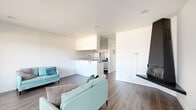 This 460 square foot, single-floor apartment in Los Angeles offers a well-designed living space that maximizes functionality. The open-concept layout seamlessly integrates the living room, kitchen, and dining area, creating a sense of spaciousness. The living room features a large window that floods the space with natural light, complemented by a modern fireplace for added ambiance. 

The kitchen, though compact, is equipped with white cabinetry, granite countertops, and essential appliances, including a stove and refrigerator. A breakfast bar serves as a transition between the kitchen and living areas, offering additional dining space.

The bedroom, measuring 130 square feet, includes a mirrored closet that enhances the perception of space. The bathroom is efficiently designed with a bathtub, toilet, and vanity, featuring granite countertops that match the kitchen.

Throughout the apartment, wood-look flooring adds warmth and continuity. The neutral color palette, predominantly white walls, creates a bright and airy atmosphere. This apartment is ideal for those seeking a modern, low-maintenance living space in an urban setting.