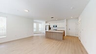 Located at 1625 Lock Ln in Madison, WI, this two-story home offers three bedrooms, two bathrooms, and a well-designed layout spread across two floors. The main level features an open-concept kitchen and living area bathed in natural light from large, blinds-fitted windows. The kitchen is outfitted with stainless steel appliances including a French door refrigerator, range, and built-in microwave, complemented by white upper cabinetry, warm wood lower cabinets, and light quartz countertops. Light hardwood flooring flows throughout the main living areas, lending a clean, modern aesthetic. The upper floor houses the bedrooms, including a generously sized primary suite. Bedrooms feature soft carpeting and ample natural light through multiple windows with views of the surrounding greenery. Closets include wire shelving systems for organized storage. The bathrooms are finished with light hardwood-style flooring, wood-toned vanities, and clean white surrounds with tub-shower combinations. The attached garage features a bright, clean interior with overhead lighting and direct interior access. The home's crisp white walls and contemporary finishes throughout create a bright, move-in-ready atmosphere.