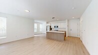 Located at 1625 Lock Ln in Madison, WI, this two-story home offers three bedrooms, two bathrooms, and a well-designed layout spread across two floors. The main level features an open-concept kitchen and living area bathed in natural light from large, blinds-fitted windows. The kitchen is outfitted with stainless steel appliances including a French door refrigerator, range, and built-in microwave, complemented by white upper cabinetry, warm wood lower cabinets, and light quartz countertops. Light hardwood flooring flows throughout the main living areas, lending a clean, modern aesthetic. The upper floor houses the bedrooms, including a generously sized primary suite. Bedrooms feature soft carpeting and ample natural light through multiple windows with views of the surrounding greenery. Closets include wire shelving systems for organized storage. The bathrooms are finished with light hardwood-style flooring, wood-toned vanities, and clean white surrounds with tub-shower combinations. The attached garage features a bright, clean interior with overhead lighting and direct interior access. The home's crisp white walls and contemporary finishes throughout create a bright, move-in-ready atmosphere.