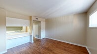Located at 510 Broadway in Columbus, Georgia, this single-floor, one-bedroom, one-bathroom residence offers a practical and cohesive layout designed for efficient everyday living. Warm hardwood-style flooring runs consistently throughout every room, lending a unified and inviting character to the entire space.

The living room serves as the welcoming entry point, featuring a front door with a side window that draws in natural light and neutral beige walls that create a clean, understated backdrop. It connects seamlessly to the kitchen via a pass-through counter with overhead cabinetry, making the space feel open and well-integrated.

A hallway links the main living area to the private quarters, providing a natural separation between spaces. The bedroom is a comfortable size, appointed with a ceiling fan and light fixture, a window with blinds for natural light and privacy, built-in shelving ideal for display or storage, and a set of sliding-door closets offering generous storage capacity.

The bathroom is efficiently laid out, featuring a full tub-and-shower combination with a decorative curtain, a toilet, and a vanity with under-sink cabinetry. Hardwood-style flooring continues into this room, maintaining the consistent aesthetic found throughout the unit.

Overall, the space presents a straightforward, functional design with cohesive finishes and thoughtful storage solutions throughout.