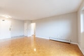 Located at 150 Culford Rd in Toronto's M6M neighbourhood, this one-bedroom, one-bathroom unit offers a well-organized layout across a single floor. The open living room is a standout space, featuring warm parquet hardwood flooring that runs throughout, large windows that flood the room with natural light, and a sliding door leading to a private balcony with views of the surrounding cityscape. Baseboard heating lines the perimeter, ensuring year-round comfort.

The galley-style kitchen is efficiently designed with grey cabinetry, granite-look countertops, a double sink, and white appliances including a stove and full-sized refrigerator. Light tile flooring and a ceiling-mounted light fixture complete the functional space.

The bedroom is a comfortable, well-proportioned room with its own large window framing an urban view, parquet hardwood floors, and baseboard heating. The clean, neutral tones throughout lend a bright and airy feel.

The bathroom is finished with classic white square tile in the tub-shower surround, maintaining a clean and timeless aesthetic. A hallway connects all rooms, providing a logical and practical flow throughout the unit.