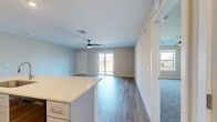Located in Avery Square in Manheim, PA, this 2-bedroom, 3-bathroom single-story home offers a well-designed open-concept layout with generous living space throughout. The main living area is anchored by durable wood-look flooring, a ceiling fan, and a sliding glass door that floods the room with natural light and provides outdoor access. The kitchen is thoughtfully appointed with crisp white shaker cabinetry, light quartz countertops, a center island with an undermount sink, and black stainless appliances including a gas range, over-the-range microwave, refrigerator, and dishwasher. Recessed lighting adds a modern touch overhead. A dedicated laundry room includes a full-size washer and dryer with overhead wire shelving for additional storage. The spacious primary bedroom features plush carpet, a ceiling fan, and a bright window with neighborhood views. The second bedroom is equally well-sized with soft carpet flooring. The three bathrooms include tiled tub/shower combinations and stylish vanities, with one bathroom showcasing a blue vanity cabinet, vessel sink, and a backlit mirror. Neutral tones and clean finishes create a bright, move-in-ready atmosphere throughout this comfortable Manheim home.