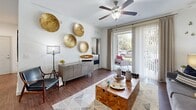 Located at 6350 Vineland Rd in Orlando, FL, this single-floor, 2-bedroom, 2-bathroom residence offers a thoughtfully designed layout with a comfortable and modern aesthetic throughout. The living room serves as the heart of the home, featuring rich wood-style flooring, a ceiling fan, and sliding glass doors that flood the space with natural light while opening to a private patio with outdoor views. The open-concept kitchen and dining area are seamlessly connected, with the kitchen showcasing dark espresso cabinetry, stainless steel appliances, a subway tile backsplash, granite countertops, a breakfast bar with pendant lighting, and warm tile flooring. The adjacent dining area provides an intimate setting with hardwood-style floors. The spacious primary bedroom features plush carpeting, a ceiling fan, and ample natural light, complemented by a dedicated closet. The second bedroom is equally well-appointed with carpet flooring and a ceiling fan. Both bathrooms are finished with tile flooring, dark vanity cabinetry, and framed mirrors. Two closets provide generous storage throughout the residence. The clean white walls and consistent finishes tie the space together, creating a bright and cohesive living environment.