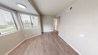 Located at 1249 East Spence Avenue in Tempe, Arizona, this 2-bedroom, 2-bathroom residence offers a well-organized single-floor layout designed for comfortable everyday living. Wood-style plank flooring flows consistently throughout the home, complementing the neutral, light-toned walls that create a clean and cohesive aesthetic.

The living and dining areas are open and airy, each equipped with ceiling fans for year-round comfort. A pass-through window connects the living area to the kitchen, enhancing the sense of openness between spaces. The kitchen features white cabinetry, speckled quartz-style countertops, and stainless steel appliances, including a refrigerator and range.

Both bedrooms are well-proportioned and include ceiling fans and mirrored sliding closet doors that add depth and reflect natural light. The primary bedroom features a sliding glass door opening to a private balcony with outdoor views, while a second balcony provides additional outdoor access. The textured ceilings in select rooms add subtle architectural character.

Both bathrooms are finished in a clean, white palette with wood-style flooring, full tub-shower combos, white vanities with brushed hardware, and built-in storage cabinetry. With five closets distributed throughout, storage is generous. This home offers a practical and comfortable layout in a prime Tempe location.