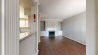 Located at 15100 Ella Blvd in Houston, TX, this single-story, three-bedroom, three-bathroom home offers a functional and comfortable layout. The living room serves as the heart of the home, featuring rich hardwood-style flooring, crown molding, a tile-surround fireplace with a classic white mantle, and built-in shelving — creating a warm and inviting atmosphere. The kitchen is equipped with ample cabinetry featuring light wood accents, granite-style countertops, and white appliances, providing a practical workspace. Each of the three bedrooms is carpeted and includes its own dedicated closet; the primary bedroom is notably spacious and is served by a walk-in closet fitted with wire shelving on multiple walls. The bathrooms are consistent in style, featuring tile-surround tub-shower combinations with chrome fixtures, vanities with granite-style countertops, and wood-style flooring. A dedicated laundry room includes washer and dryer hookups along with overhead wire shelving for additional storage. Two hallways connect the various areas of the home efficiently. The attached garage provides direct interior access and overhead door operation. Overall, the home presents a clean, neutral palette throughout, offering a solid foundation for personalization.