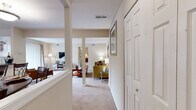 Located at 8542 Foxborough Drive in Savage, Maryland, this single-floor residence offers a practical and comfortable layout across two bedrooms and two full bathrooms. The entrance hall leads into a carpeted living room highlighted by a distinctive structural column, warm neutral tones, and ample space for relaxing and entertaining. Adjacent to the living area is a dedicated dining room that connects seamlessly to the kitchen, which features oak cabinetry, dark granite-style countertops, white appliances including a range, dishwasher, and built-in microwave, along with a window that lets in natural light. The primary bedroom is generously sized, featuring bold accent wall color, a large closet, carpeted flooring, and a window overlooking the outdoors. The second bedroom mirrors the comfortable feel of the primary. Both bathrooms are finished with oak vanities, tile flooring, and well-lit mirrors. A hallway with closet storage provides additional organization. Utility rooms support the home's functional needs. The patio extends the living space outdoors, offering a peaceful view of mature trees and well-maintained landscaping—a serene retreat in a quiet residential neighborhood.