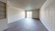 Located at 3111 E Fourth St in Tucson, AZ, this 2-bedroom, 2-bathroom residence offers a well-organized single-floor layout designed for comfortable everyday living. The open living room features wood-look laminate flooring, textured walls, and a textured ceiling, creating a neutral and functional space. A ceiling fan is centrally positioned, and a sliding glass door leads to a private patio, allowing natural light to fill the room. The kitchen connects seamlessly to the living area via a pass-through counter and is equipped with warm wood-toned cabinetry, white appliances including a refrigerator, dishwasher, and range, a double-basin sink, and a window that brings in additional natural light. Both bedrooms are carpeted and feature textured ceilings and sliding closet doors for ample storage. The primary bedroom is generously sized with direct access to a private bathroom. The two bathrooms feature wood-look flooring, warm wood vanity cabinetry with white countertops, and clean white fixtures. One bathroom includes a full tub-shower combination with tile surround. Three hallways connect the various rooms efficiently throughout the unit, contributing to a logical and easy-to-navigate floor plan.