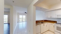 Located at 1775 NW Seventh Street in Miami's vibrant Little Havana neighborhood, this single-floor unit offers a clean, bright, and functional layout throughout. The interior is finished with crisp white walls and large-format white ceramic tile flooring across the main living areas, creating a light and airy atmosphere.

The kitchen is well-appointed with white cabinetry, rich granite countertops, a stainless steel sink, and a full suite of white appliances including an electric range, over-the-range microwave, dishwasher, and refrigerator. The kitchen connects seamlessly to the main living area, which is illuminated by natural light from a sliding glass door that opens to a private balcony offering open city views.

The living area features a ceiling fan and flows into the rest of the unit with ease. The bedroom is finished with wood-look laminate flooring and includes access to a spacious walk-in closet, providing generous storage. The bathroom is clean and functional, featuring a granite-topped vanity with white cabinetry, a large mirror, and a full tub-and-shower combination with white tile surround. The consistent use of white tones and granite accents throughout creates a cohesive and polished aesthetic well-suited to the Miami lifestyle.