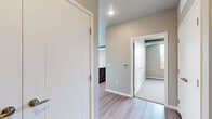 Located at 412 3rd St E in Hastings, MN, this well-appointed two-bedroom, two-bathroom residence offers a thoughtfully designed single-floor layout with a contemporary urban aesthetic. The open-concept living room is a standout space, featuring light hardwood-style flooring, large corner windows that flood the room with natural light, and sliding glass doors leading to a private balcony with outdoor views. Exposed metallic ductwork running along the ceiling adds an industrial character throughout the unit.

The kitchen is finished with rich dark cabinetry, granite countertops, stainless steel appliances, and light hardwood-style flooring, complemented by a window overlooking the surrounding area. Both bedrooms are carpeted and offer a calm, neutral palette with windows providing natural light and views of the greenery outside. Each bedroom benefits from closet space, including a walk-in closet with wire shelving for organized storage.

The two bathrooms are clean and functional — one features a tub-shower combo with a dark vanity and granite countertop, while the second offers a standalone shower with sleek chrome fixtures. Neutral tones and modern finishes carry throughout, creating a cohesive and move-in-ready living environment.