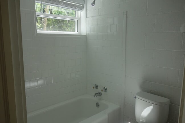 Completely refinished bathroom with new toilet and sink. - 116 Howard Dr