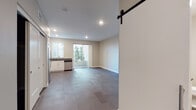 Located at 2629 Harrison St in Oakland, CA, this modern single-floor residence offers a well-designed open layout with clean lines and contemporary finishes throughout. The living and dining area is generously sized, featuring warm-toned hardwood-style flooring, recessed lighting, and neutral walls that create a bright, welcoming ambiance. A sliding glass door opens directly to a private outdoor patio, bringing in natural light and seamless indoor-outdoor connectivity.

The kitchen is thoughtfully designed with white cabinetry, dark countertops, and a full suite of stainless steel appliances, including a refrigerator, range with microwave above, and dishwasher. A window over the sink adds natural light to the cooking space.

A standout architectural detail is the sleek barn door, which provides stylish access to the bathroom area. The bathroom features a soaking tub and clean white finishes. In-unit stacked washer and dryer are conveniently located nearby, adding to the practicality of the space. Closet storage is also available within the unit. Recessed lighting throughout and consistent flooring tie the entire space together with a cohesive, modern aesthetic.
