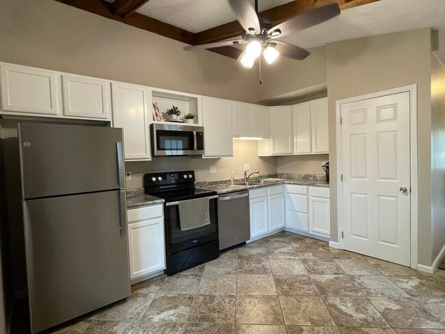 Kitchen-Vaulted Ceiling, Ceiling Fan, Appliances including stainless dishwasher and microwave - 1277 Tallberry Dr