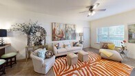 This thoughtfully designed 2-bedroom, 2-bathroom residence offers a comfortable and functional single-story layout. The open-concept living room is bright and welcoming, featuring large windows with horizontal blinds that invite abundant natural light, carpet flooring, a ceiling fan, and direct access to an outdoor patio through a glass-paneled door. The adjoining kitchen is well-equipped, showcasing rich dark cherry wood cabinetry, granite-style countertops, black appliances including a refrigerator, range, microwave, and dishwasher, and tile flooring throughout. A pass-through window connects the kitchen to the living area, enhancing the open feel of the space. The primary bedroom is generously sized, featuring carpet flooring, a ceiling fan, and a sliding-door closet with built-in shelving. The second bedroom is similarly carpeted and benefits from a window with natural light. Both bathrooms are well-appointed with tile flooring, rich wood vanity cabinetry, and tub-shower combinations with sliding glass enclosures. A hallway and dedicated closet provide additional storage and connectivity throughout the home. The overall ambiance is warm and inviting, with neutral tones complementing the rich cabinetry finishes throughout.